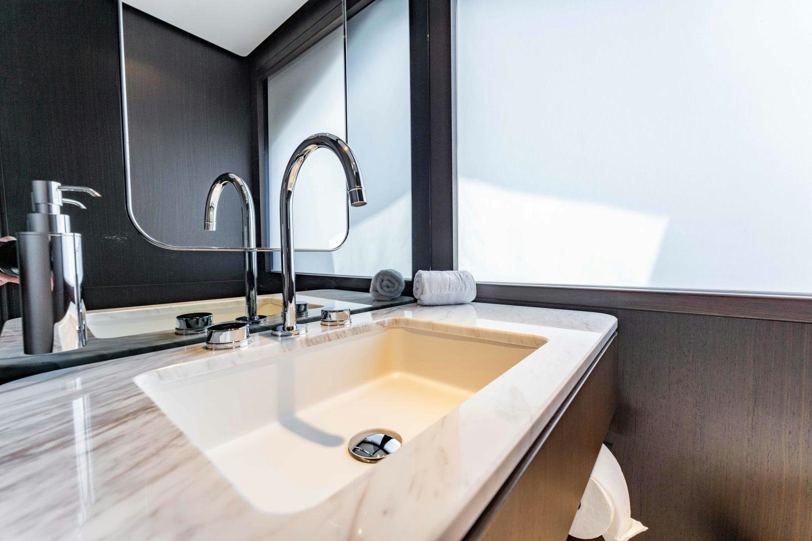 a bathroom with a sink and a mirror aboard BESO Yacht for Sale