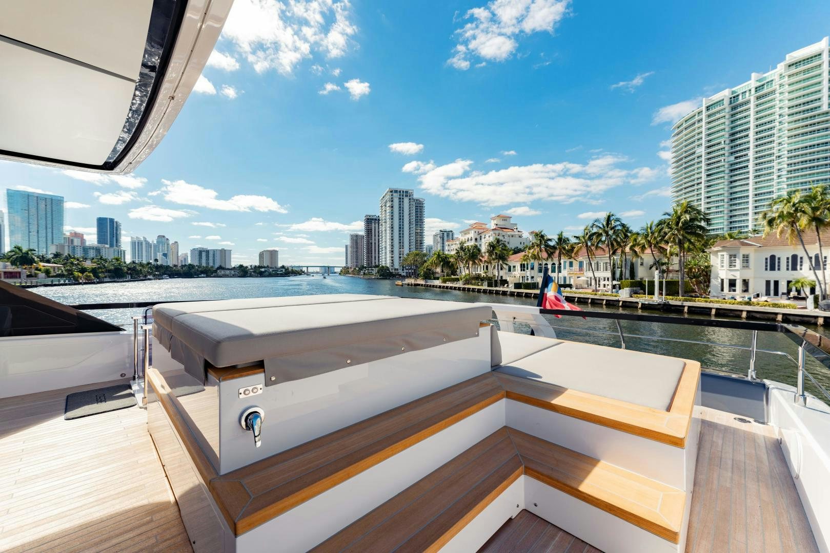 a deck with a view of a city and water aboard BESO Yacht for Sale