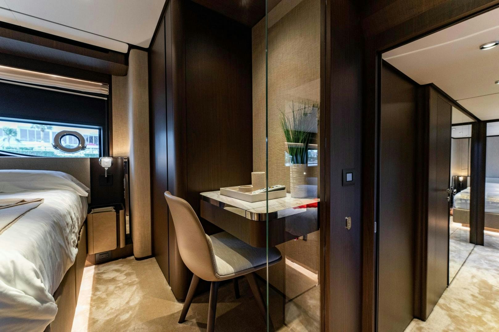 a room with a desk and a bed aboard BESO Yacht for Sale