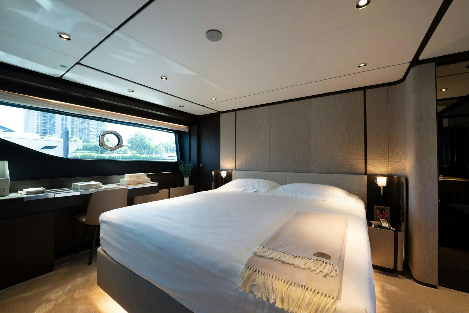 a room with a bed and a large window aboard BESO Yacht for Sale