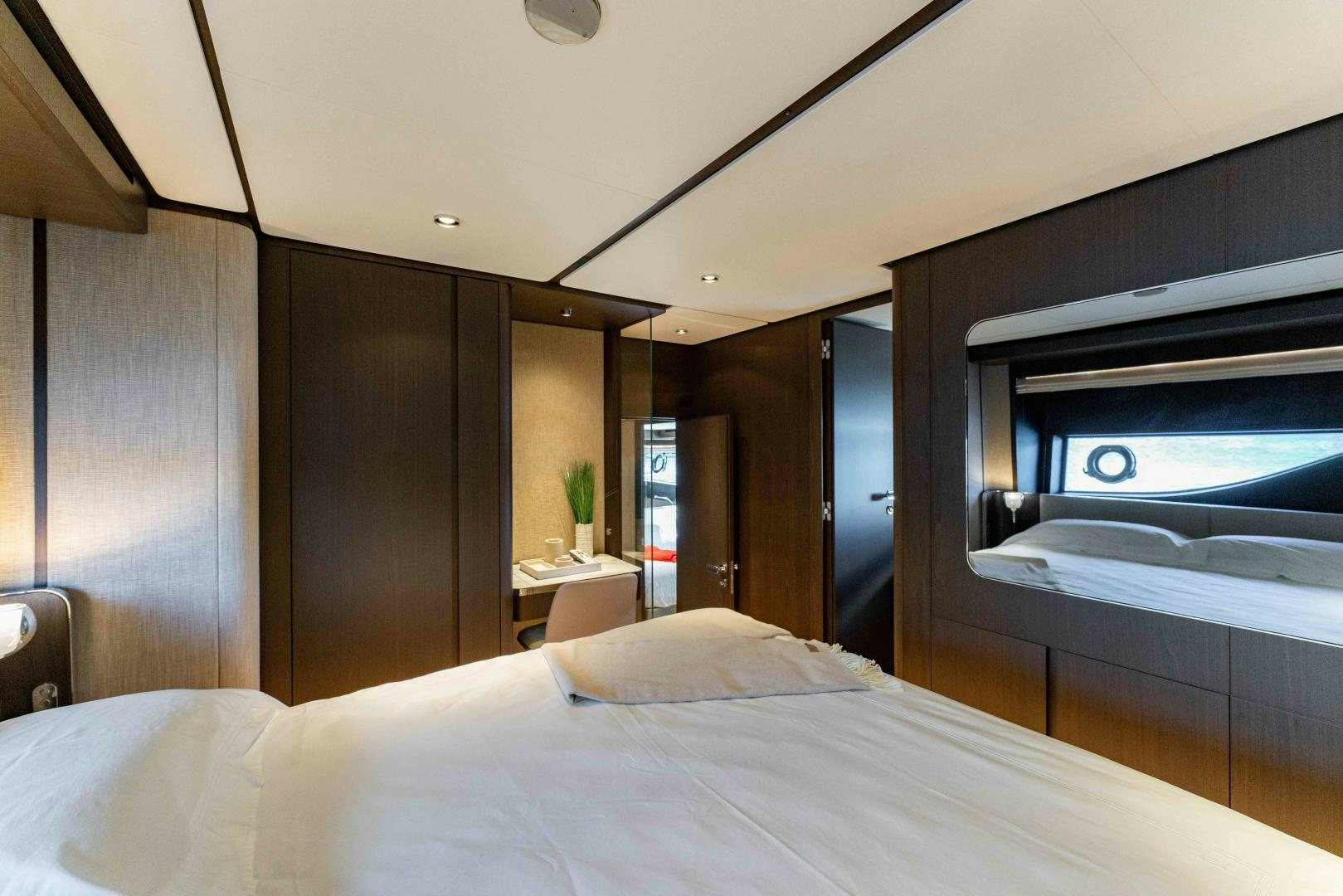 a bed with a white sheet aboard BESO Yacht for Sale