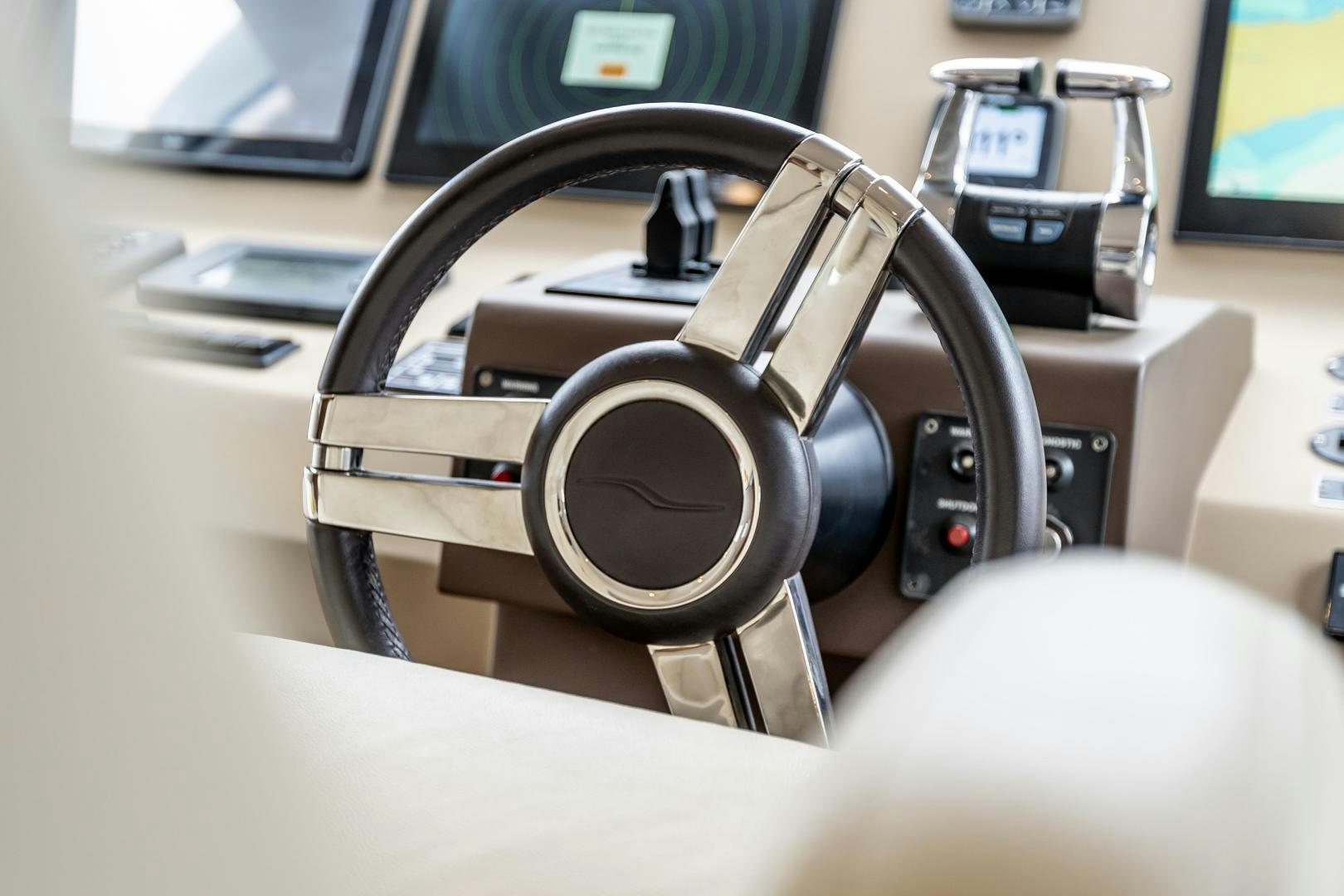 a close-up of a car steering wheel aboard VICTORY Yacht for Sale