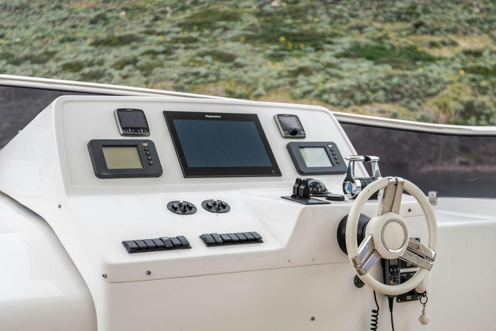 a white car with a screen and buttons on the dashboard aboard VICTORY Yacht for Sale