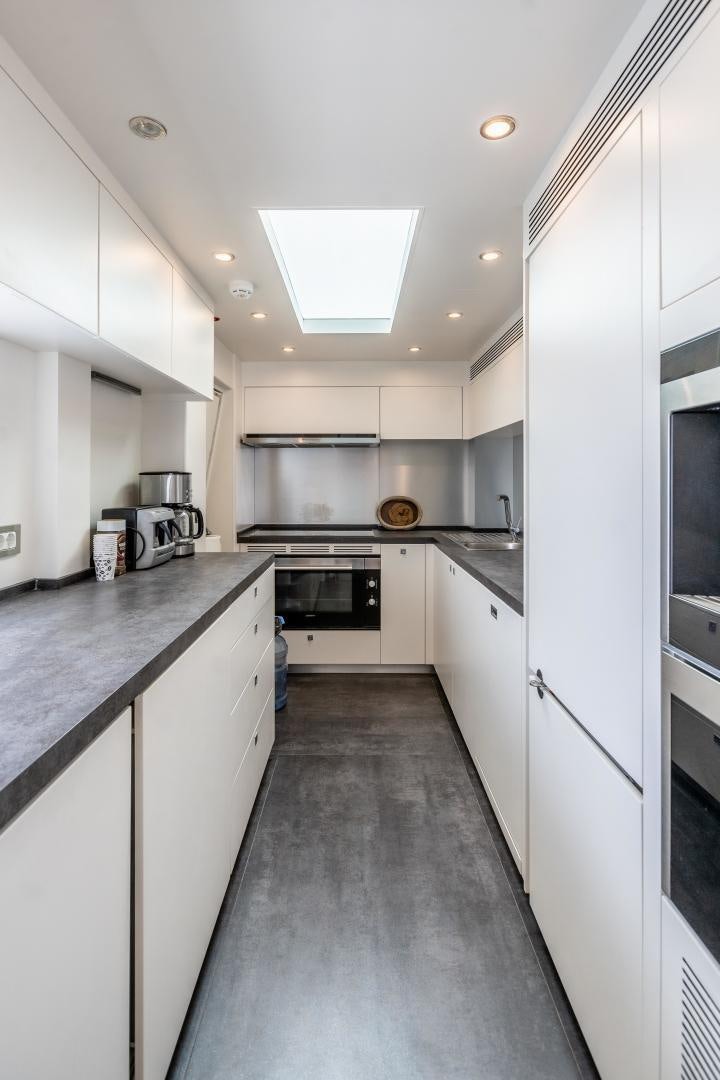 a kitchen with white cabinets aboard VICTORY Yacht for Sale