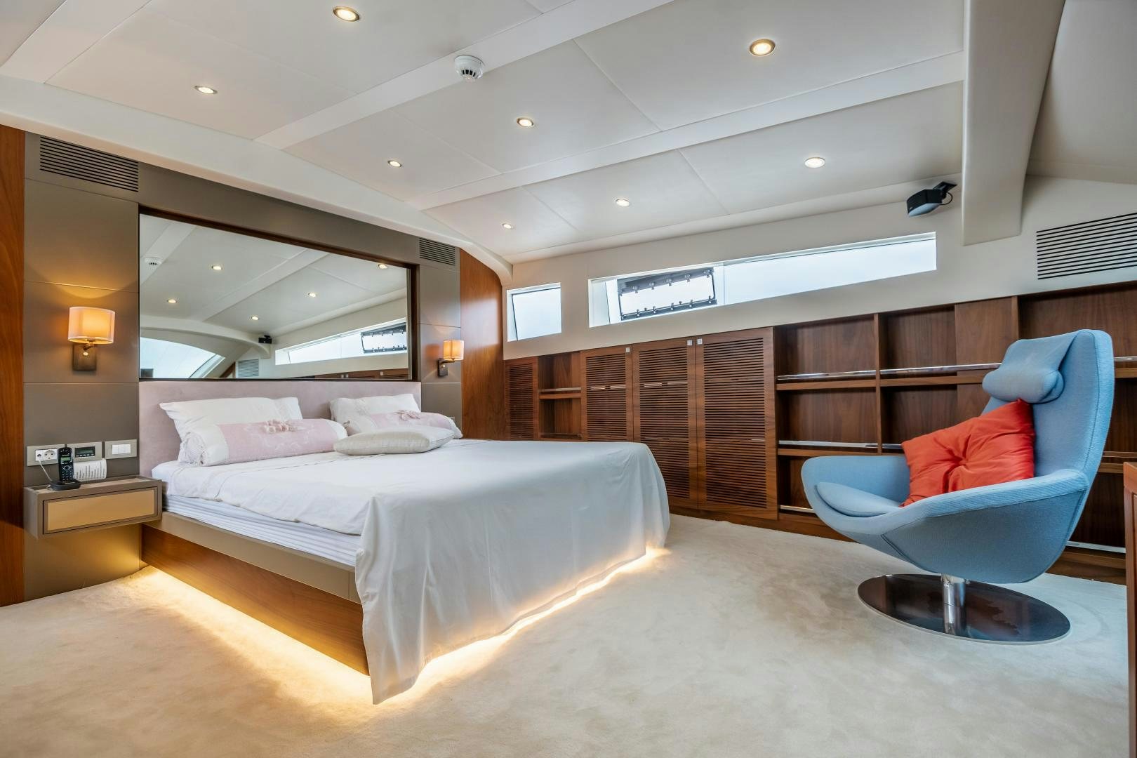 a room with a bed and a chair aboard VICTORY Yacht for Sale