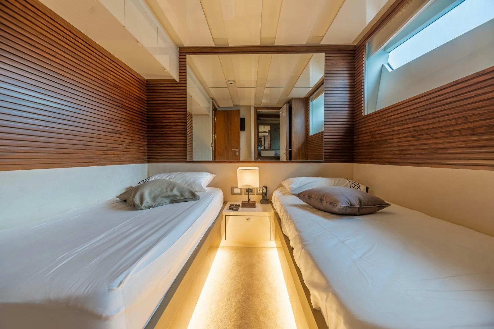a room with beds and a wood wall aboard VICTORY Yacht for Sale
