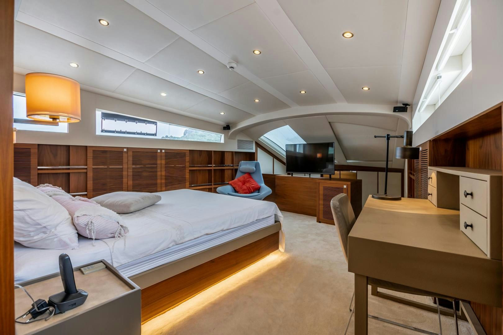 a bedroom with a bed and desk aboard VICTORY Yacht for Sale