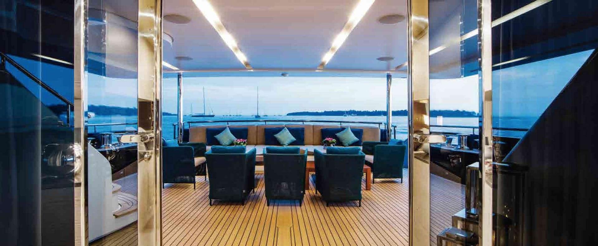 a room with a couch and a table and chairs aboard COFINA Yacht for Sale