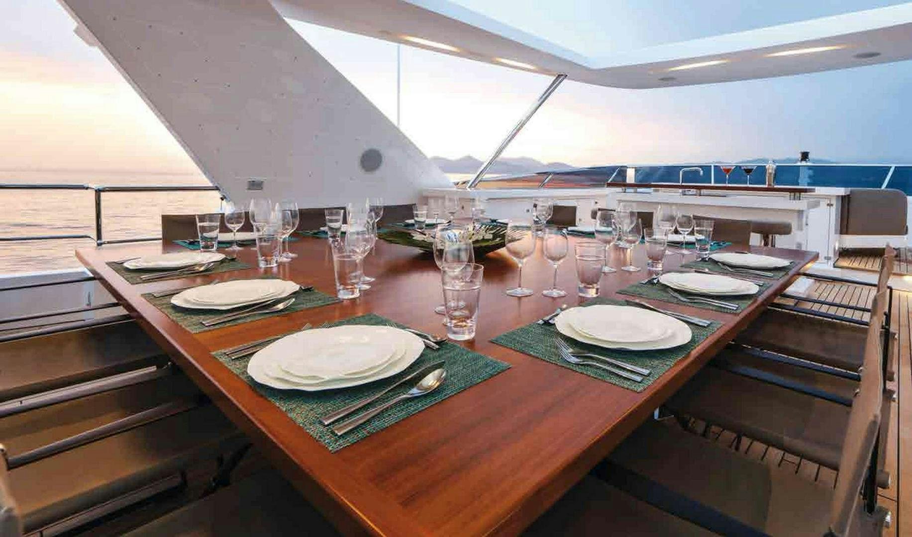 a table with plates and glasses on it aboard COFINA Yacht for Sale