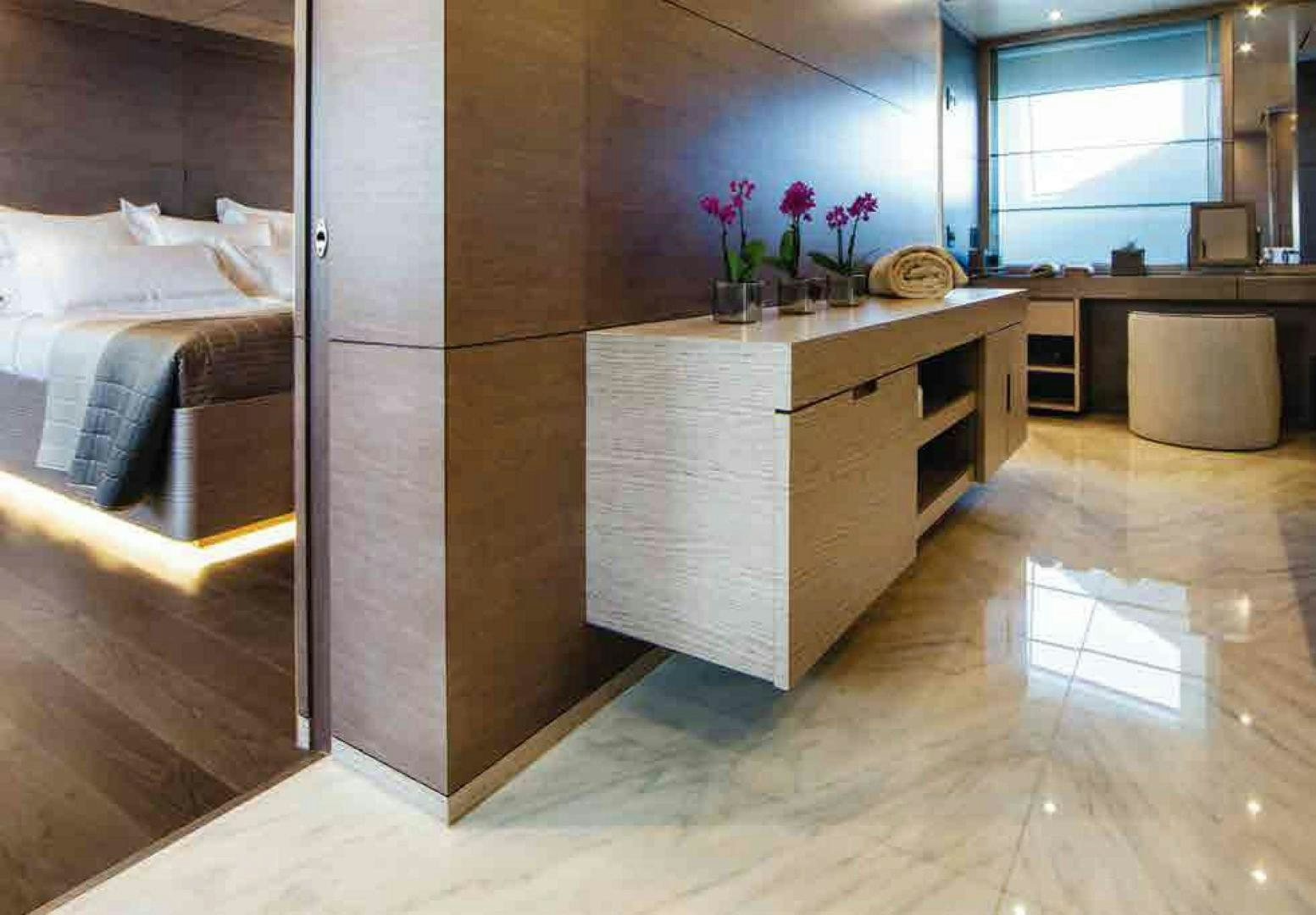 a room with a bed and desk aboard COFINA Yacht for Sale