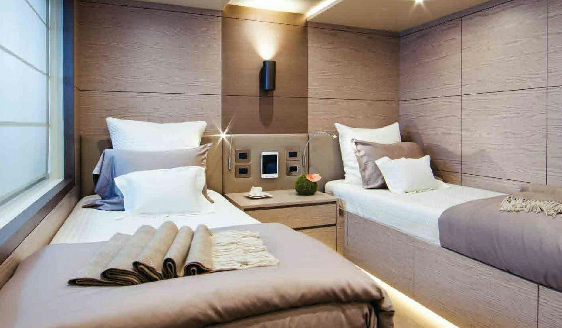 a room with two beds aboard COFINA Yacht for Sale