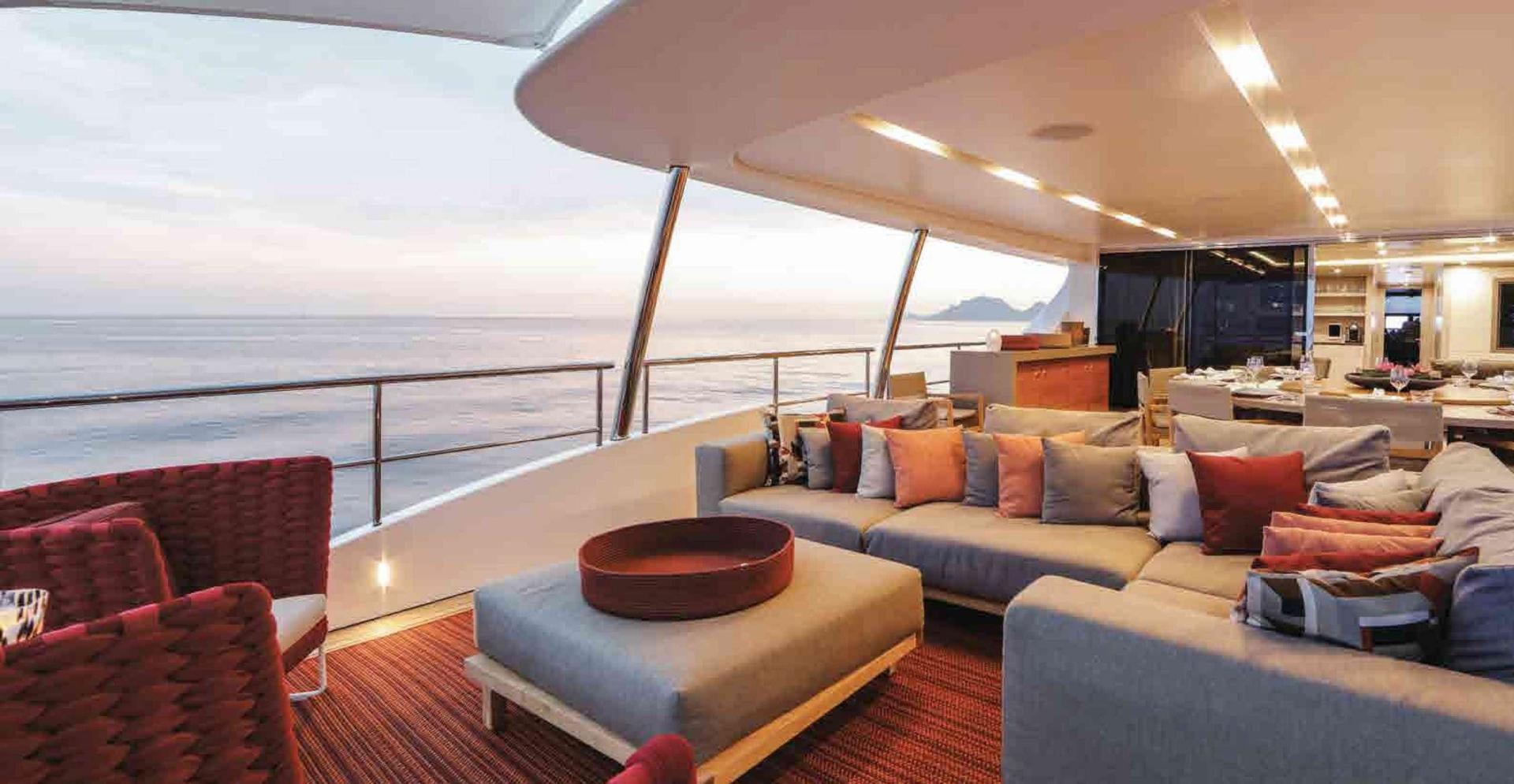 a large living room with a large balcony aboard COFINA Yacht for Sale