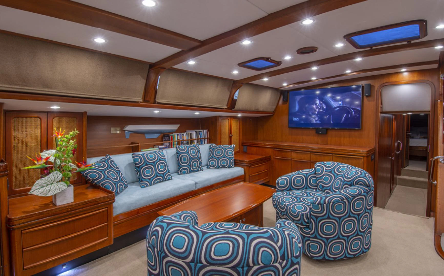 a living room with a blue couch aboard EAGLE'S NEST Yacht for Sale