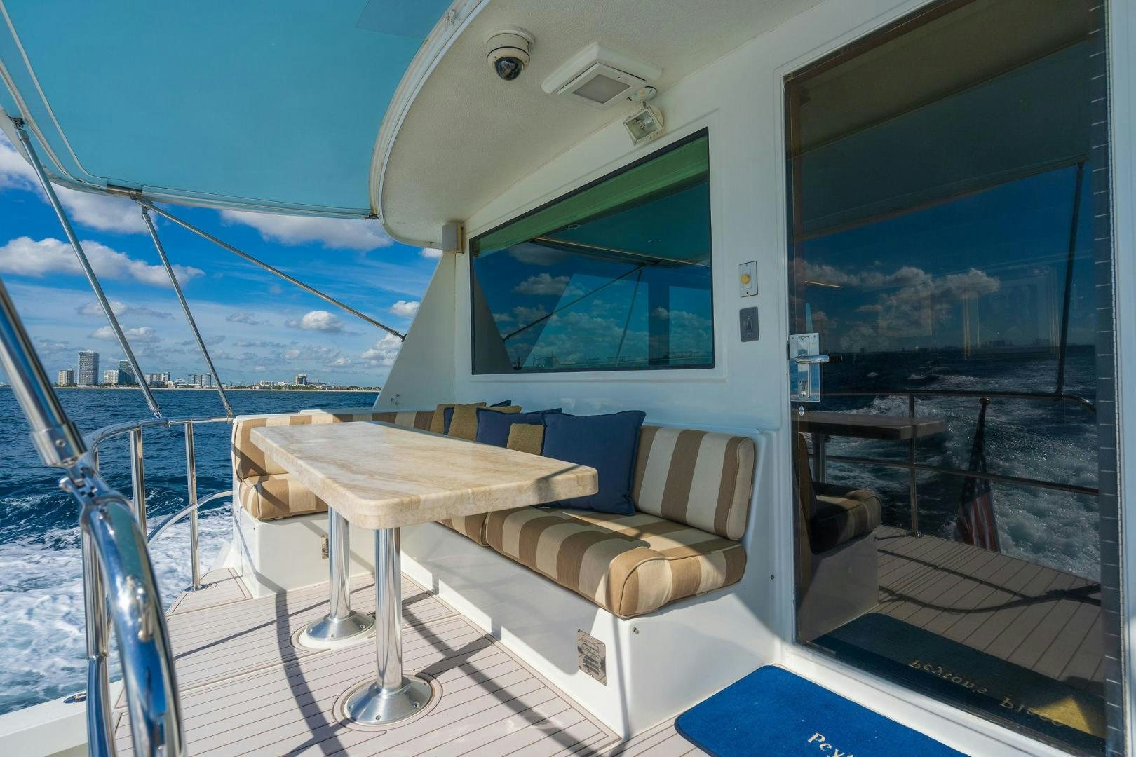 a boat with a table and chairs aboard PEYTONS PLACE Yacht for Sale