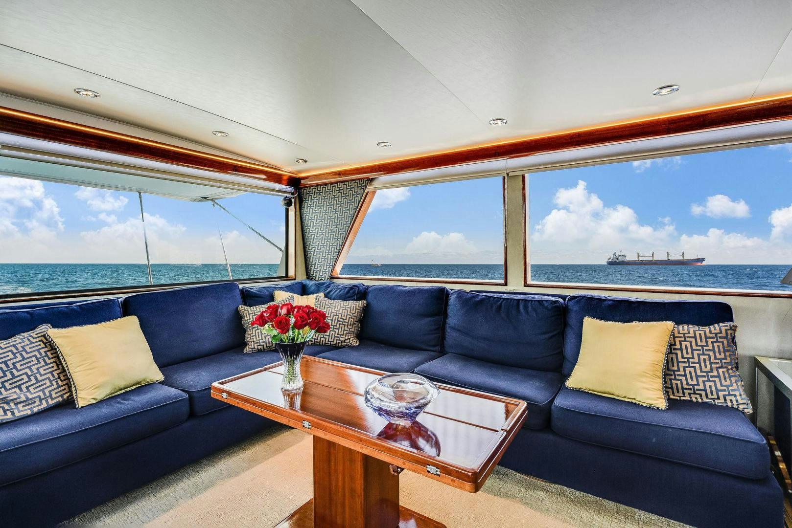 a living room with a large window aboard PEYTONS PLACE Yacht for Sale