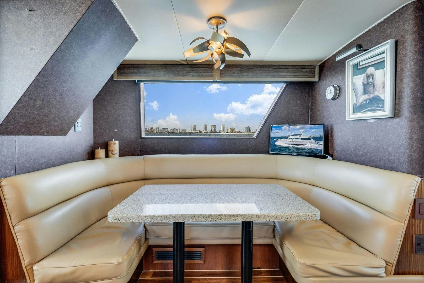 a living room with a large screen aboard PEYTONS PLACE Yacht for Sale