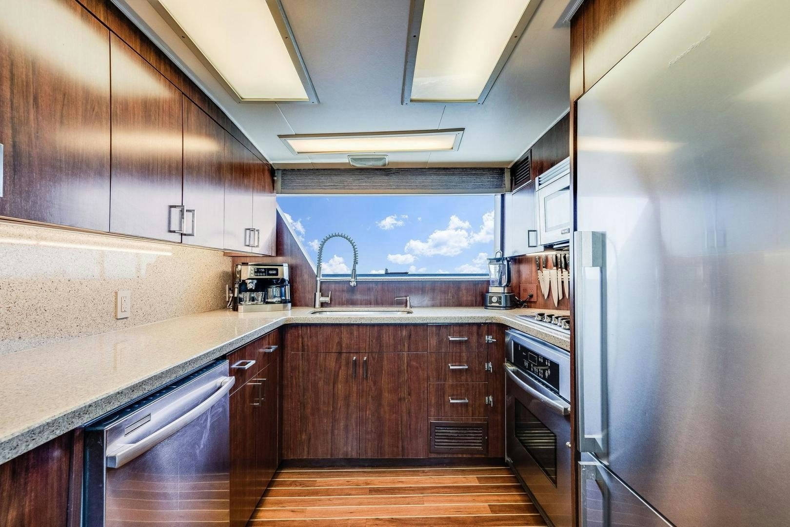 a kitchen with a large refrigerator aboard PEYTONS PLACE Yacht for Sale