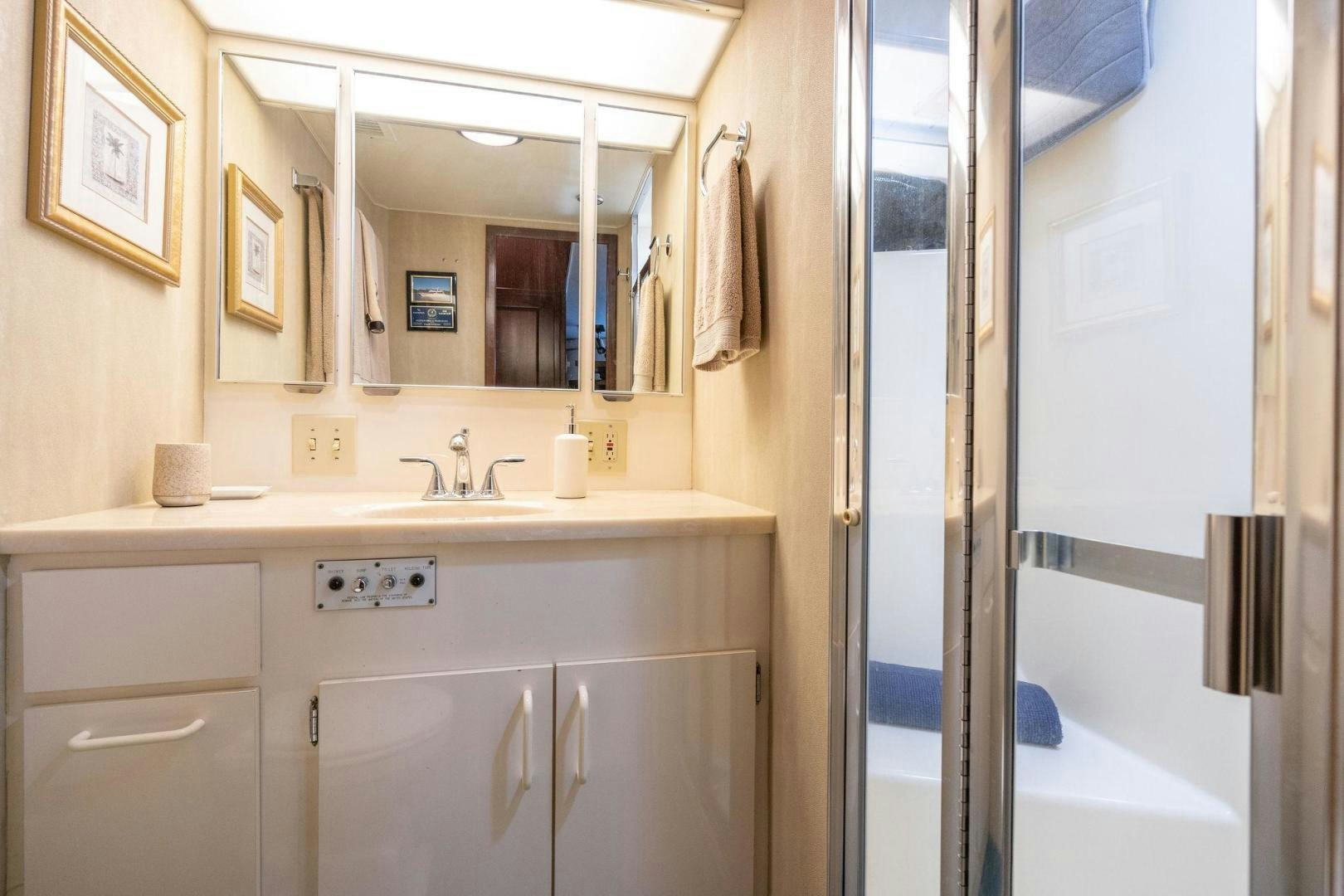 a bathroom with a sink and a mirror aboard PEYTONS PLACE Yacht for Sale