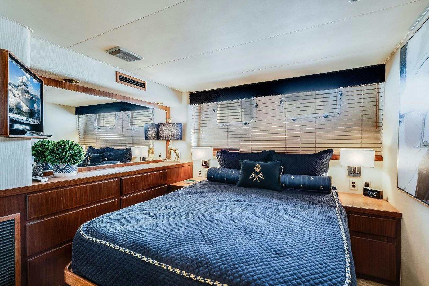 a bedroom with a bed and a television aboard PEYTONS PLACE Yacht for Sale