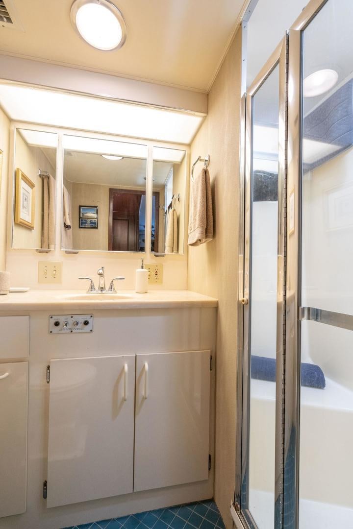 a bathroom with a sink and a mirror aboard PEYTONS PLACE Yacht for Sale