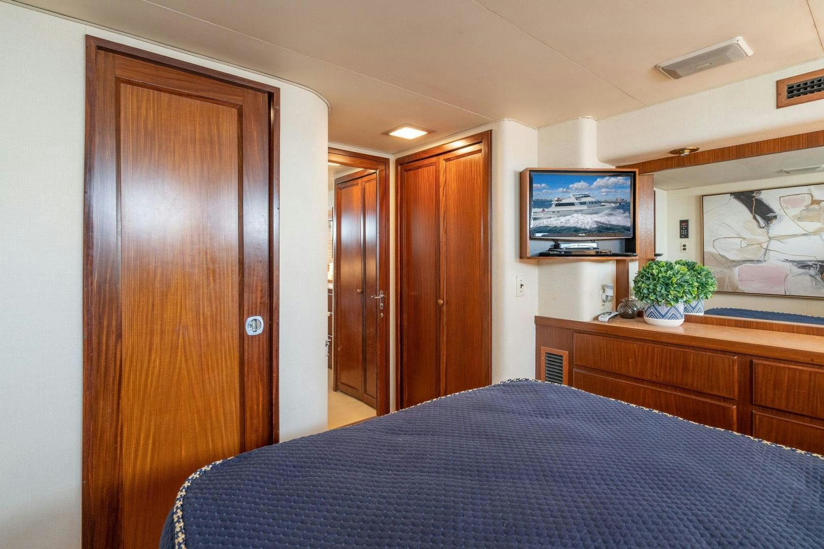 a bedroom with a bed and a television aboard PEYTONS PLACE Yacht for Sale
