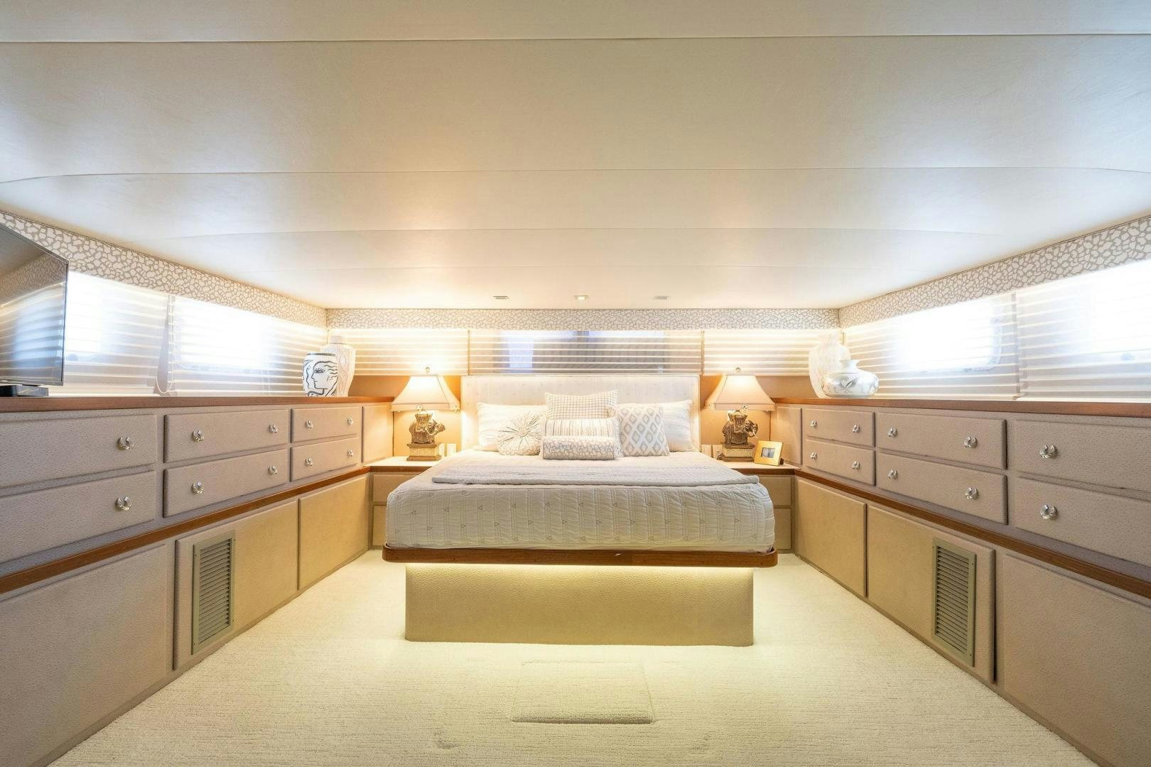 a bedroom with a bed and a desk aboard PEYTONS PLACE Yacht for Sale