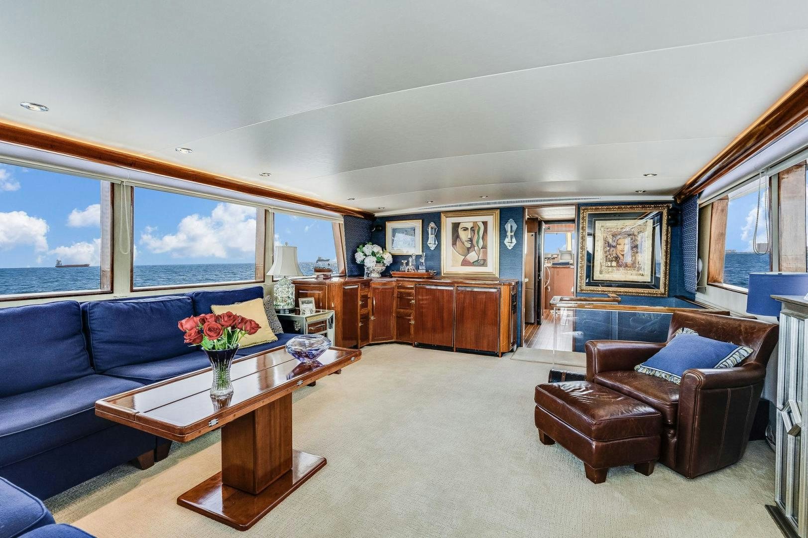 a living room with a blue couch and a coffee table aboard PEYTONS PLACE Yacht for Sale