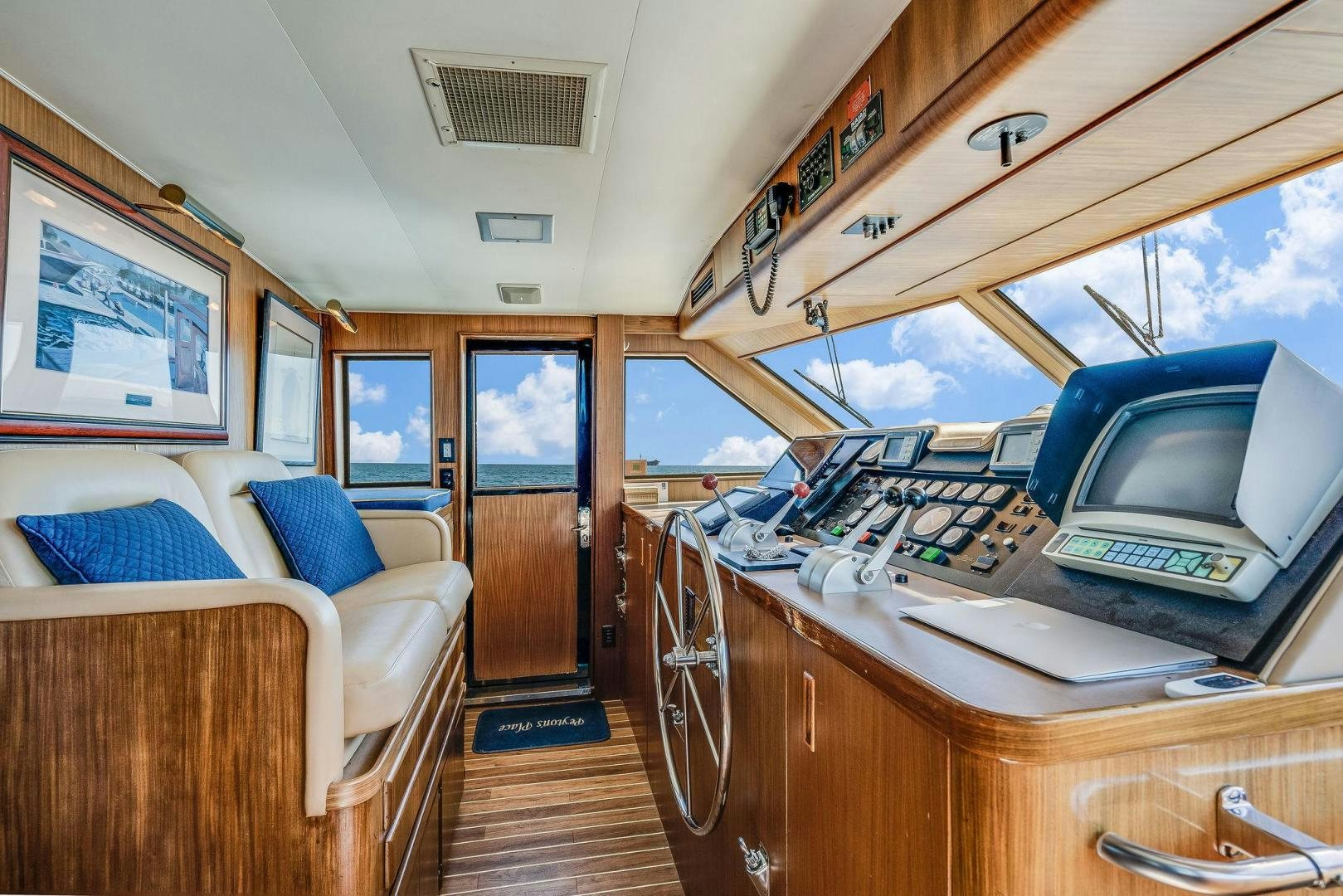 a living room with a desk and a bed aboard PEYTONS PLACE Yacht for Sale