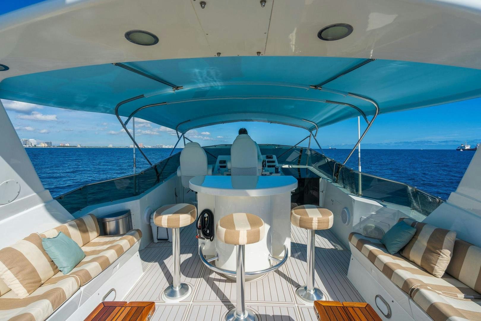 a boat with a table and chairs aboard PEYTONS PLACE Yacht for Sale