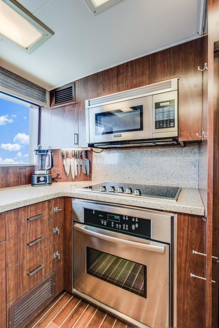 a kitchen with a stove and microwave aboard PEYTONS PLACE Yacht for Sale