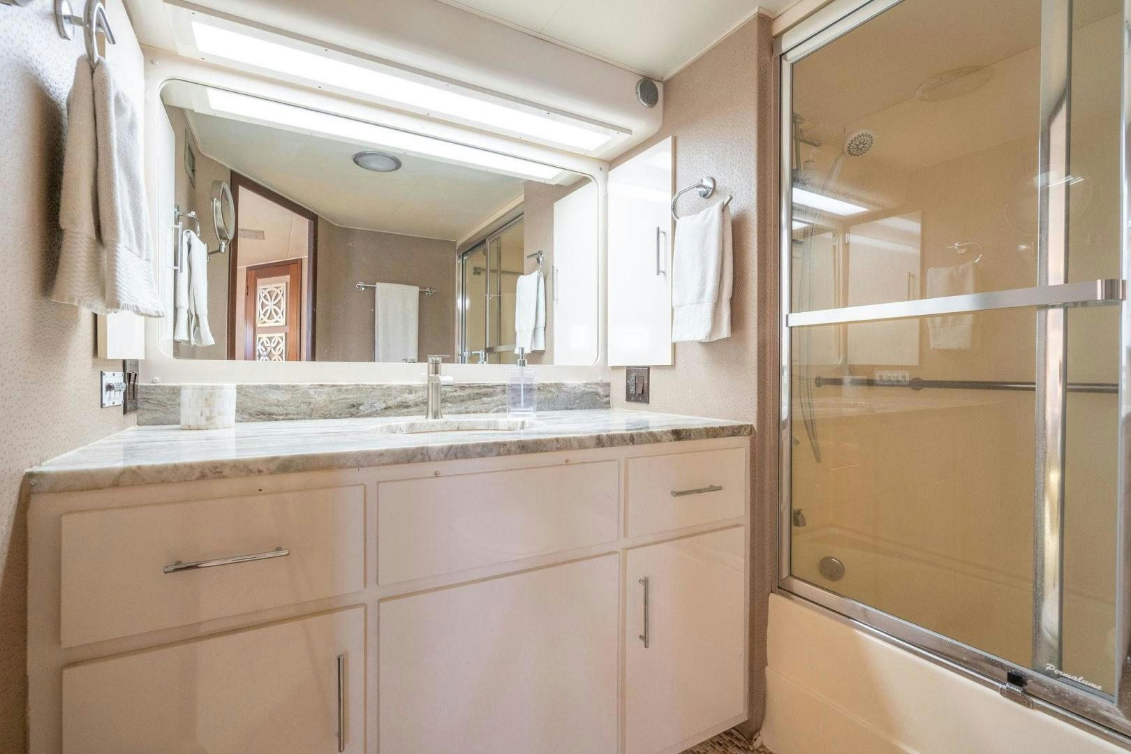 a bathroom with a large mirror aboard PEYTONS PLACE Yacht for Sale
