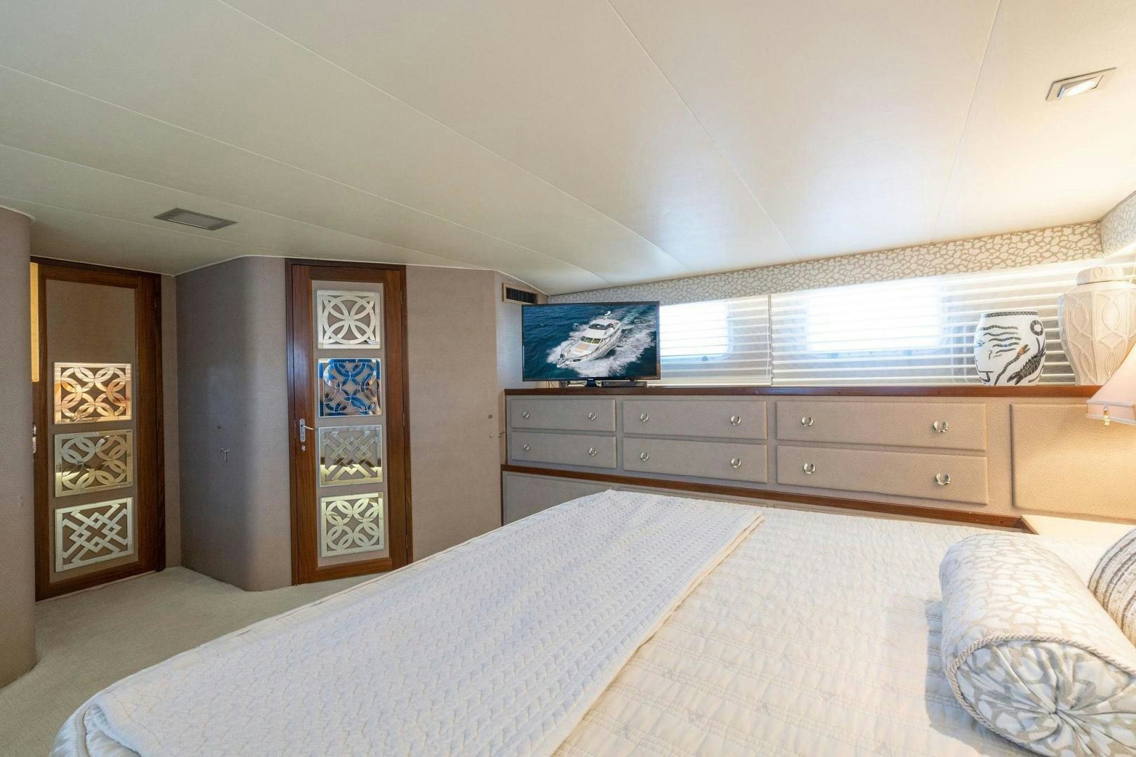 a bedroom with a bed and a dresser aboard PEYTONS PLACE Yacht for Sale