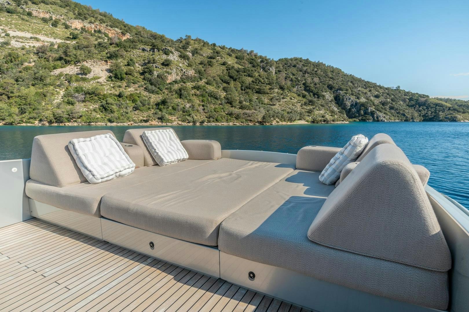 a couch on a deck overlooking a body of water aboard ALYSSA 1 Yacht for Sale