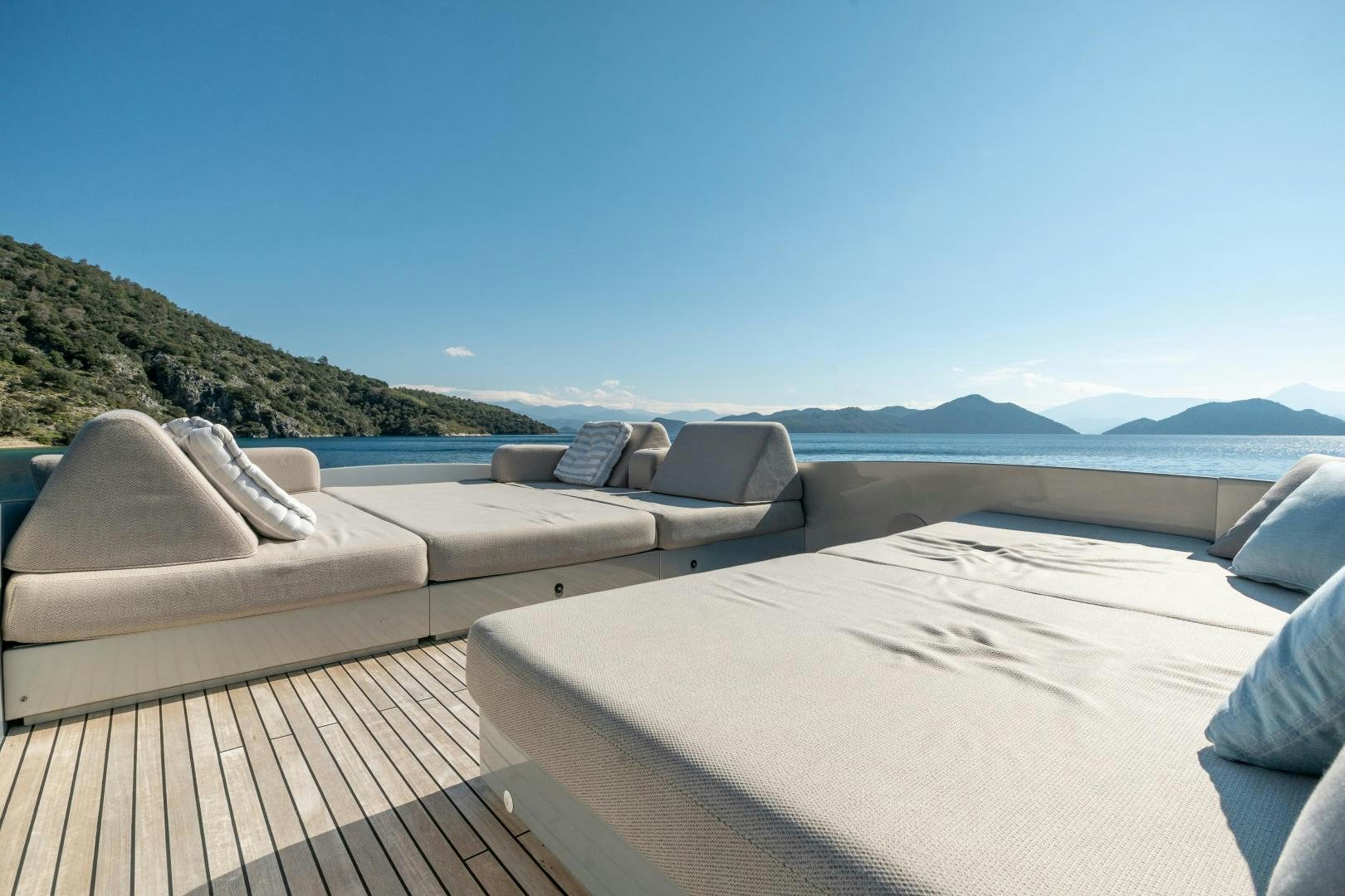 a deck overlooking a beach aboard ALYSSA 1 Yacht for Sale
