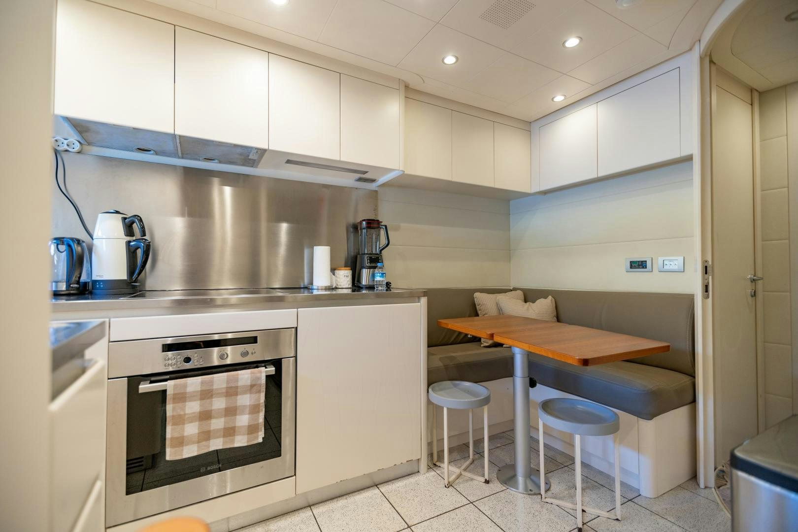 a kitchen with a stove and a table aboard ALYSSA 1 Yacht for Sale