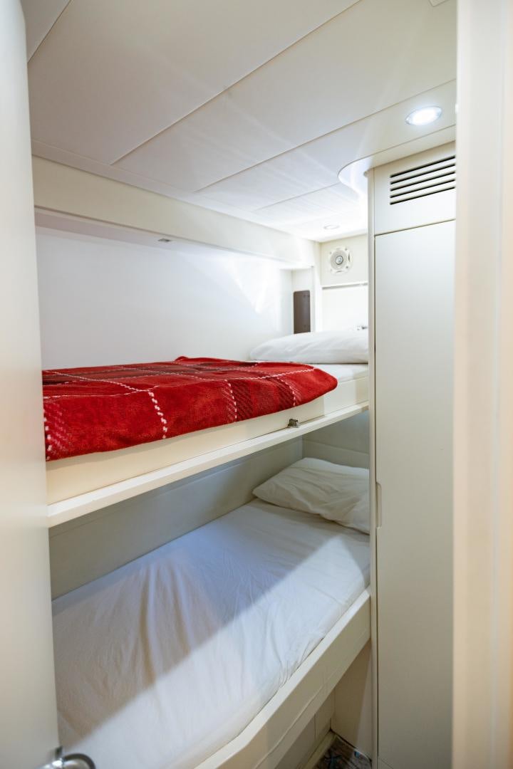 a room with white walls and red pillows aboard ALYSSA 1 Yacht for Sale