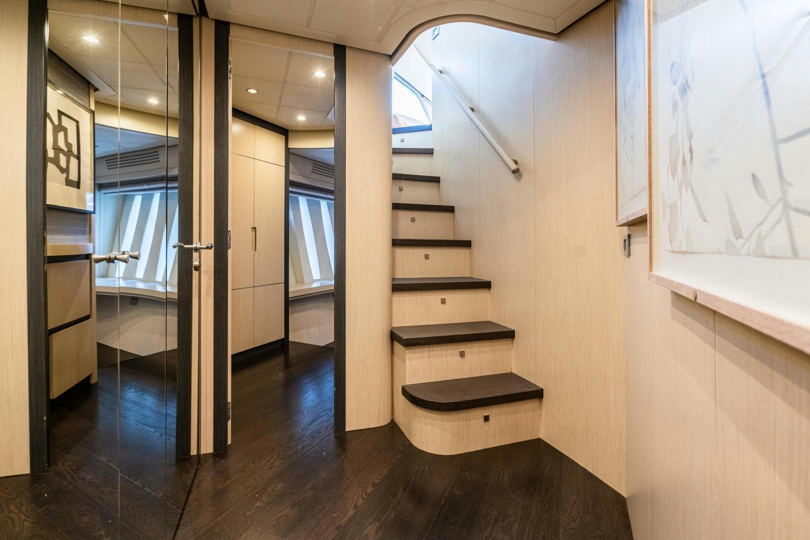 a room with a staircase and a large window aboard ALYSSA 1 Yacht for Sale