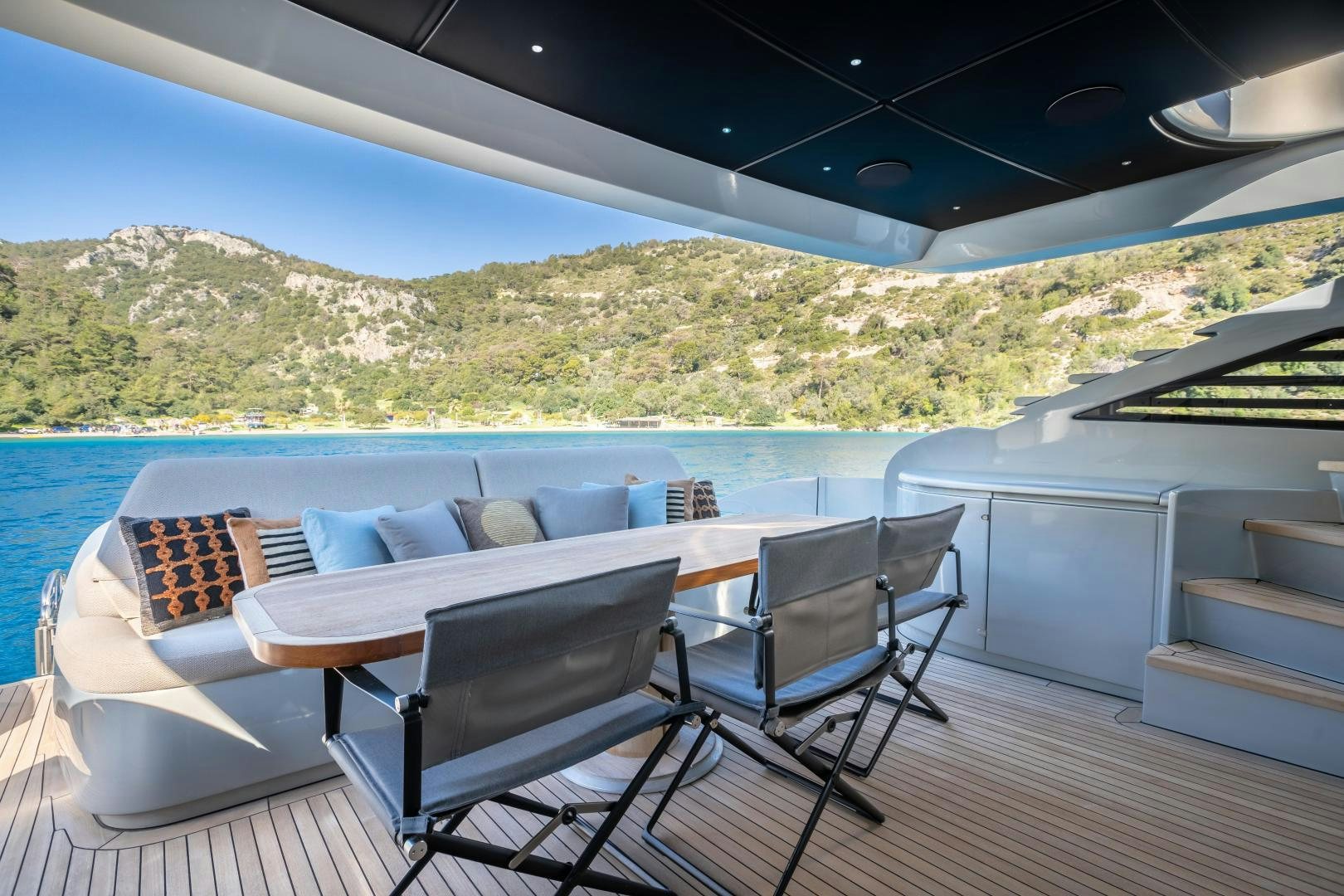 a table and chairs on a deck overlooking a large body of water aboard ALYSSA 1 Yacht for Sale