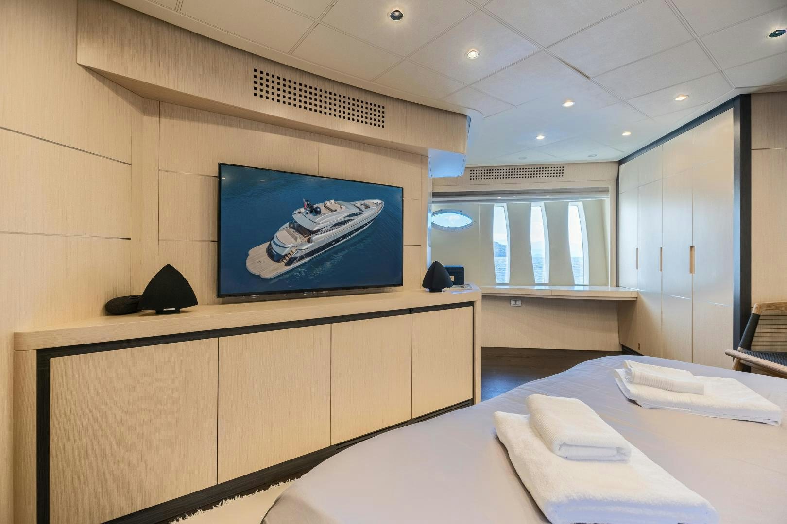 a room with a table and a tv on the wall aboard ALYSSA 1 Yacht for Sale