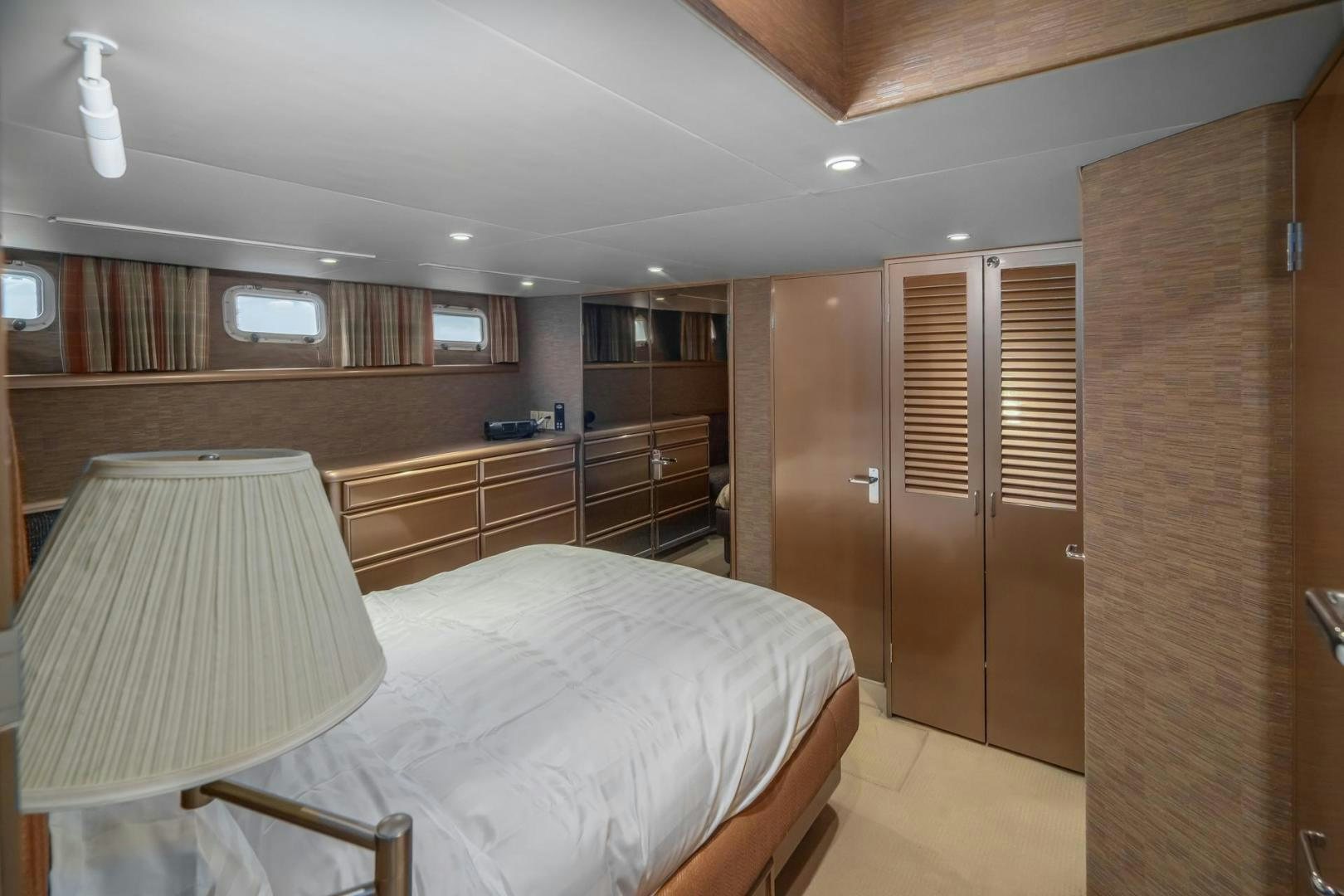 a bedroom with a bed and a desk aboard PARAGON Yacht for Sale