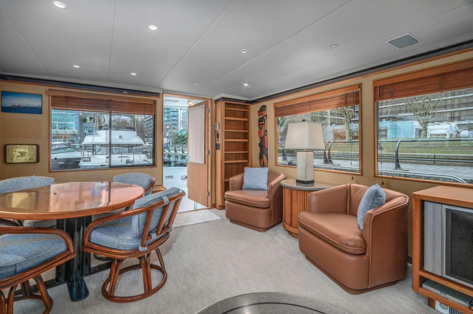 a living room with a table and chairs aboard PARAGON Yacht for Sale
