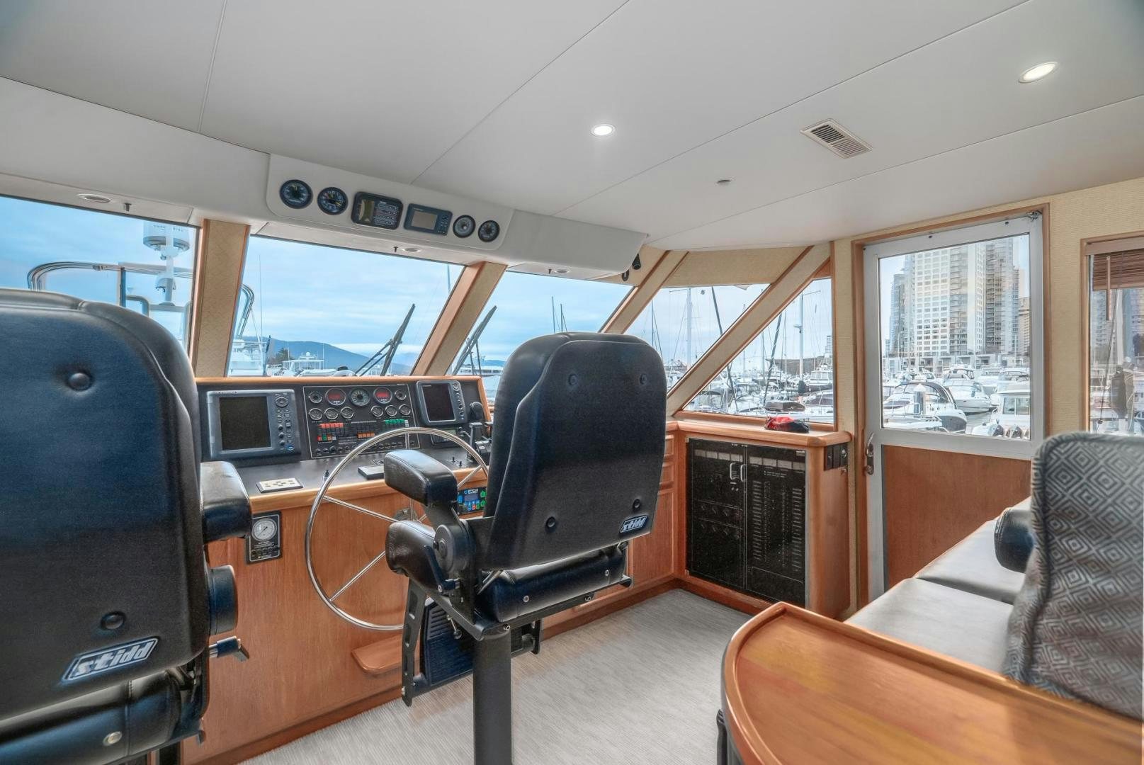 a room with a chair and a table and a tv aboard PARAGON Yacht for Sale