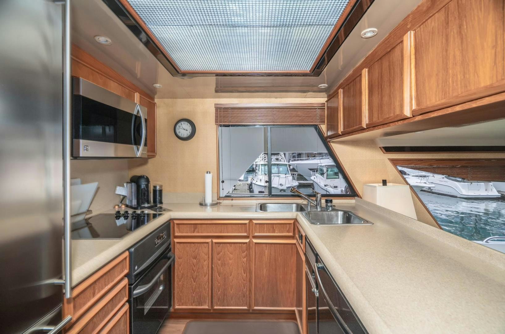 a kitchen with wooden cabinets aboard PARAGON Yacht for Sale