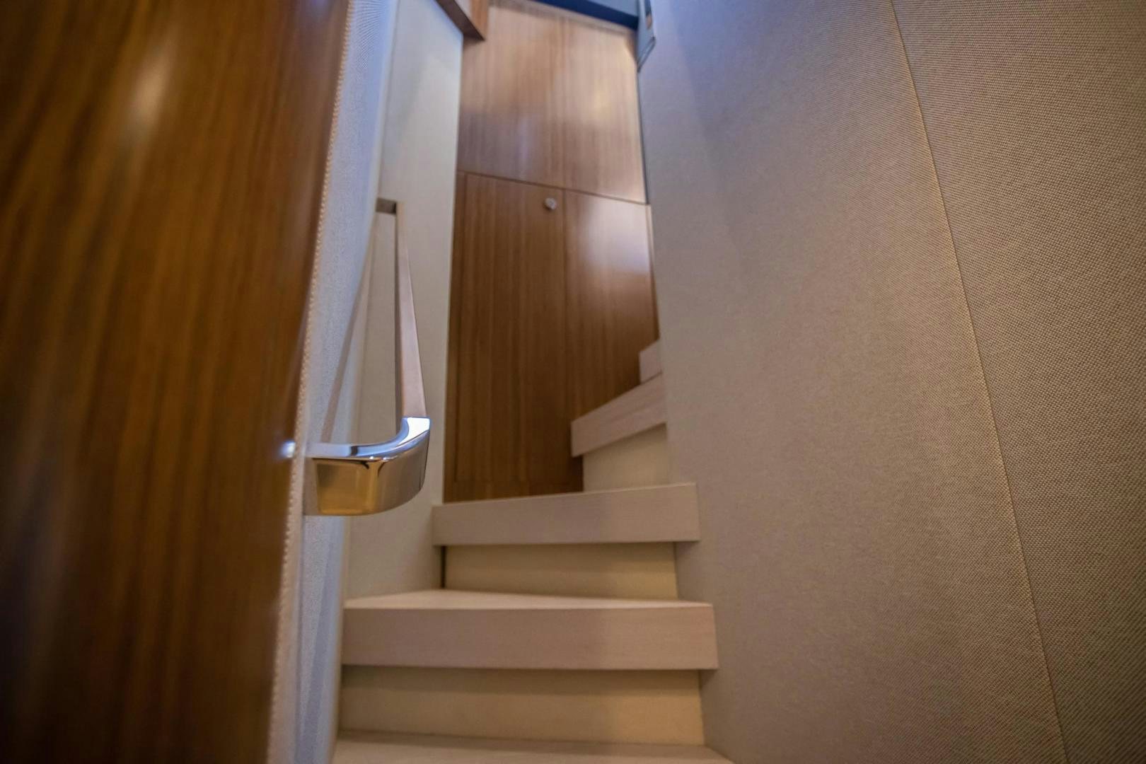 a staircase leading to a door aboard ROY Yacht for Sale