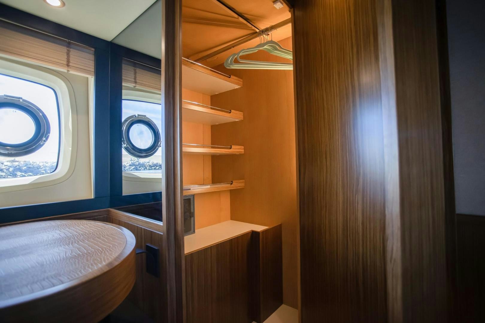 a wooden staircase with a window aboard ROY Yacht for Sale