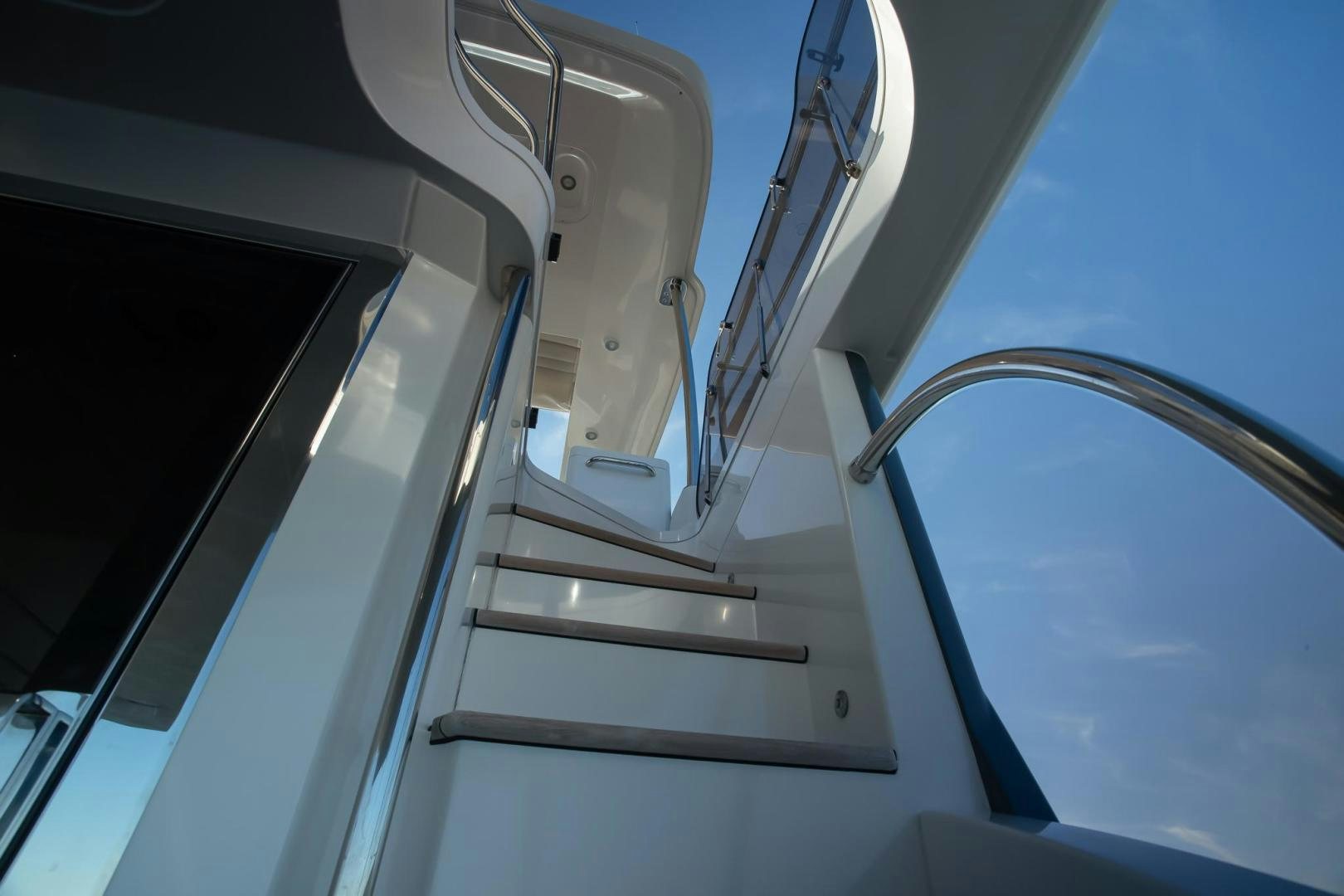 a white staircase with a metal frame aboard ROY Yacht for Sale