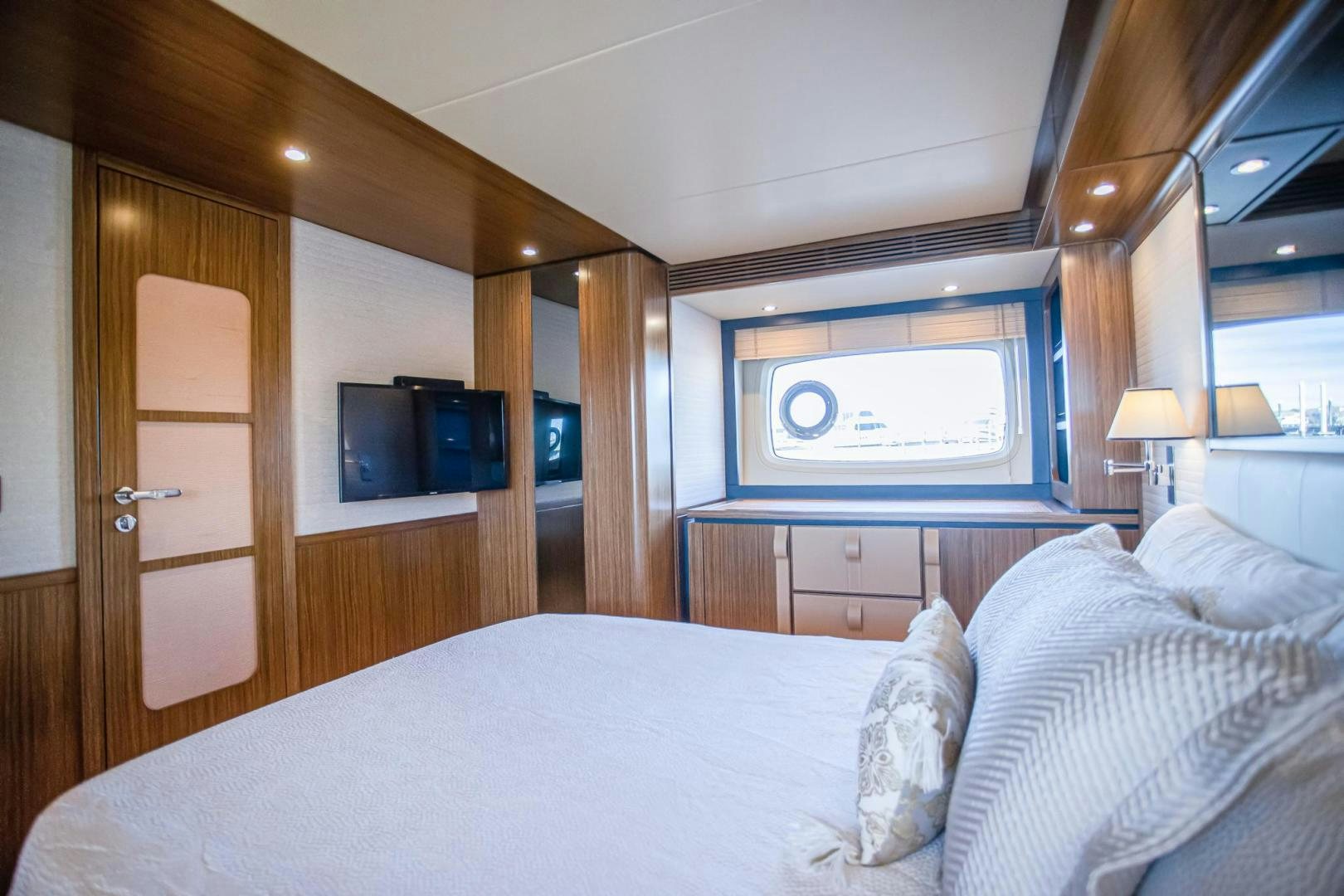 a bedroom with a bed and a television aboard ROY Yacht for Sale