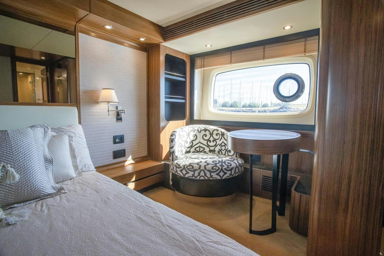 a bed and a table in a room aboard ROY Yacht for Sale