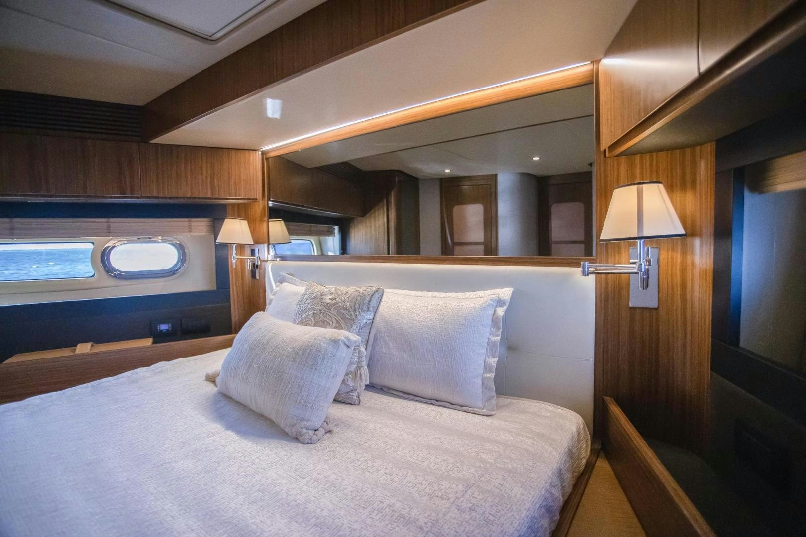 a bed with pillows and a lamp aboard ROY Yacht for Sale