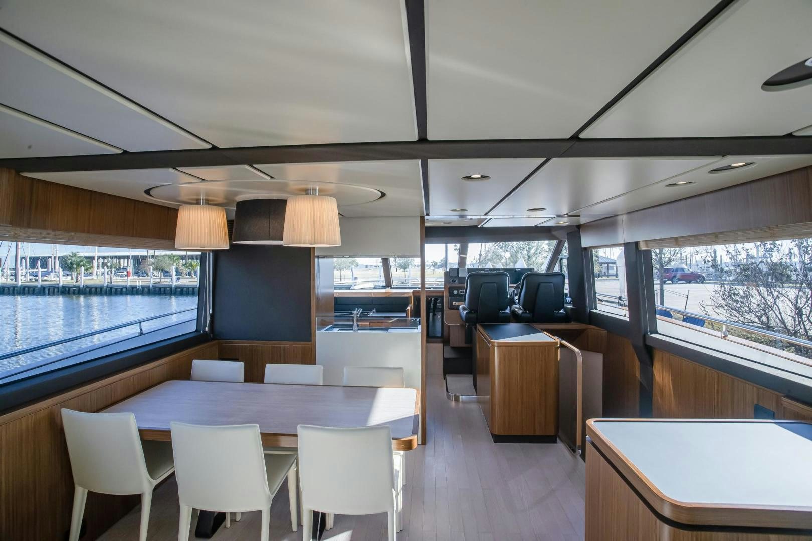 a room with tables and chairs aboard ROY Yacht for Sale